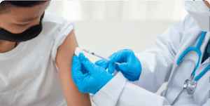 Healthcare worker administering vaccine to patient.