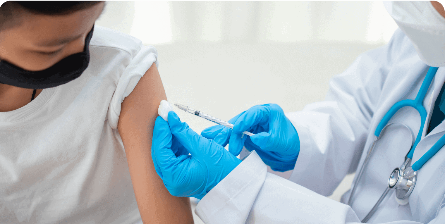 Healthcare worker administering vaccine to patient.