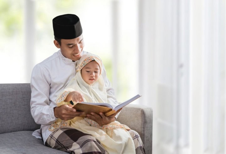 Father and child reading a book together.