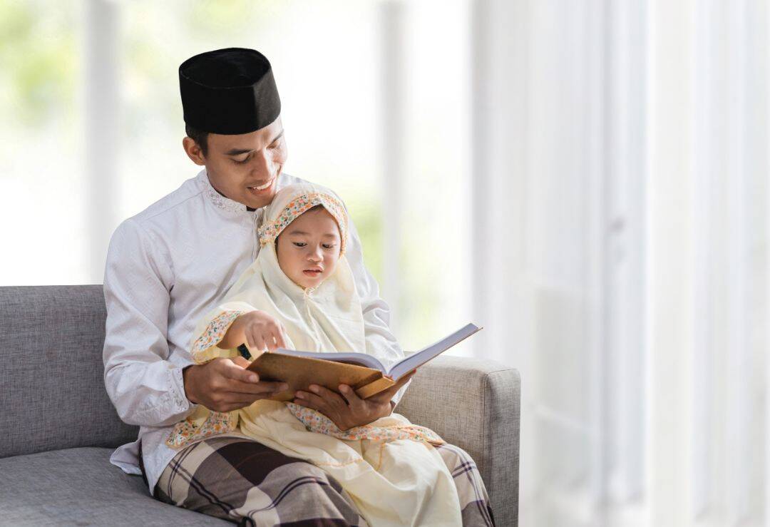 Father and child reading a book together.